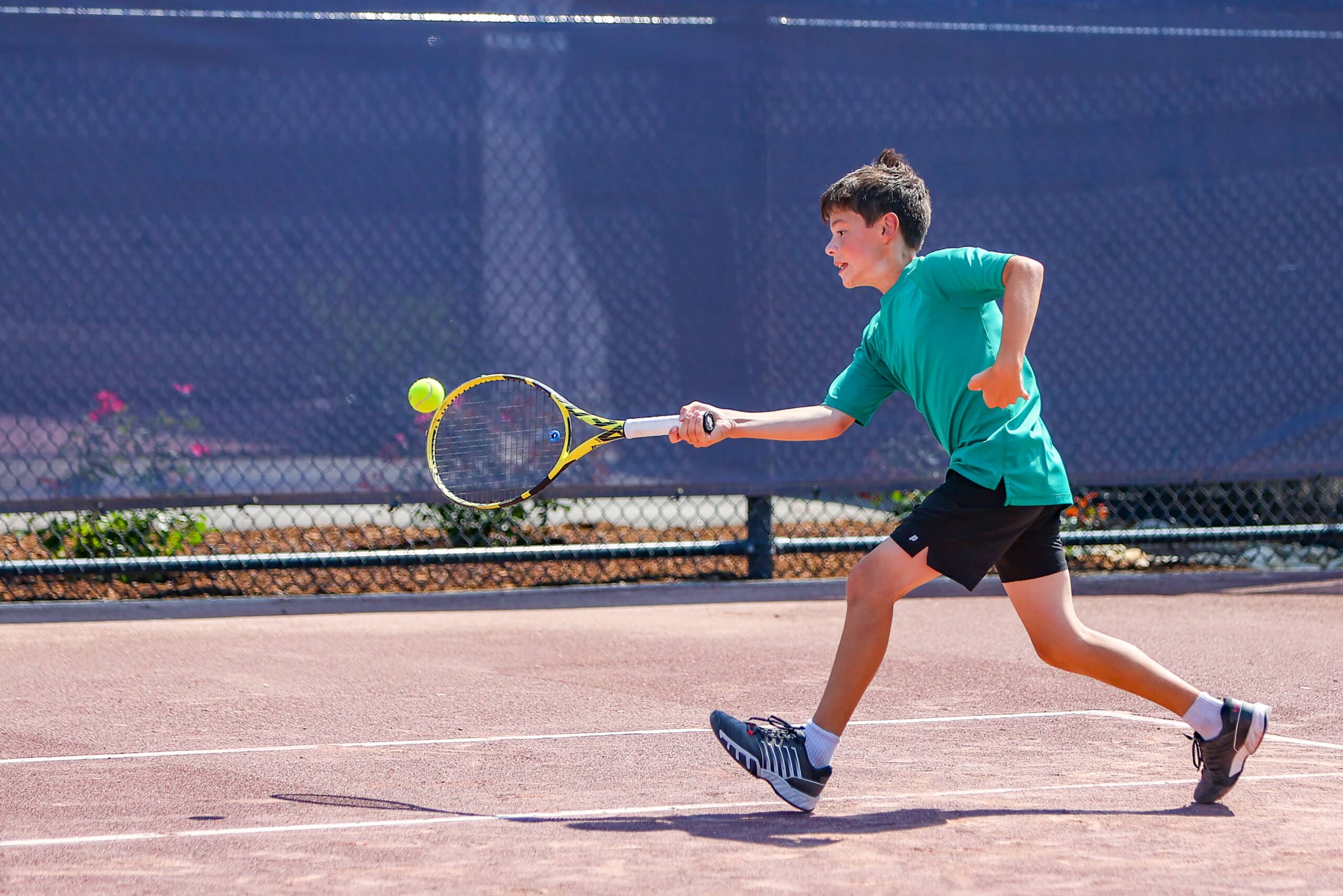 kid playing tennis