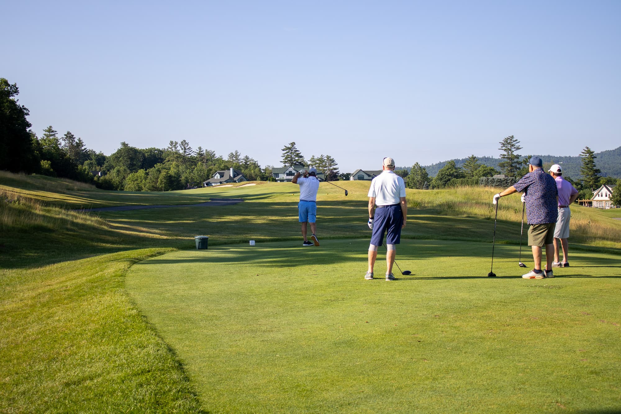 Senior golfers teeing off during the Profile Senior Golfers Association Golf Tournament at Owl’s Nest Resort in New Hampshire.