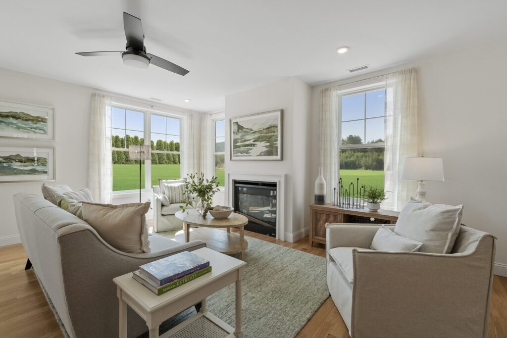 Living room with a fireplace and large windows in a South Lake townhome
